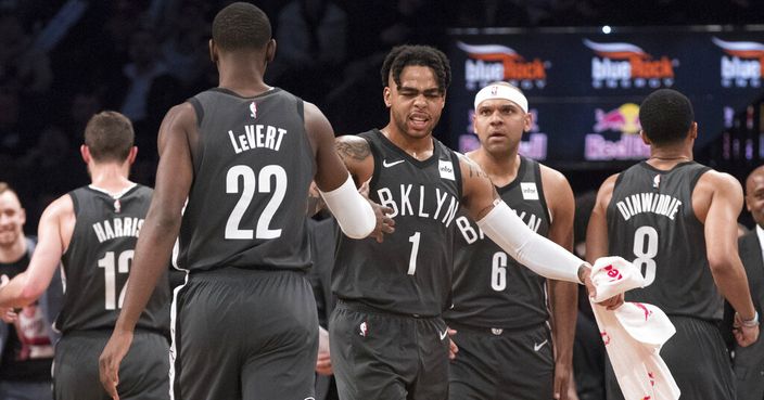 Brooklyn Nets guard D'Angelo Russell (1) and guard Caris LeVert (22) react as they go to the bench during a time out in the first half of an NBA basketball game against the Boston Celtics, Saturday, March 30, 2019, in New York. (AP Photo/Mary Altaffer)