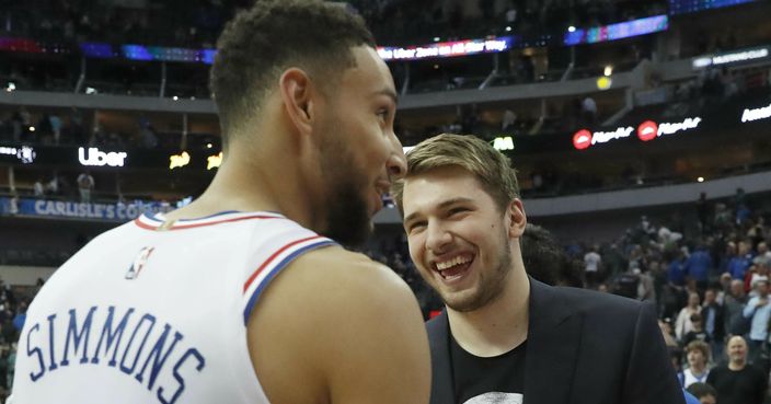 Dallas Mavericks' Luka Doncic, center, visits with Philadelphia 76ers' Ben Simmons (25) and Boban Marjanovic after an NBA basketball game in Dallas, Monday, April 1, 2019. AP Photo/LM Otero)