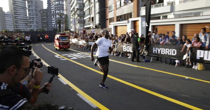 Jamaican sprinter Usain Bolt races against a mototaxi, in Lima, Peru, Tuesday, April 2, 2019. Bolt, who is on a publicity campaign for Puma, went on to win the 50-meter race. (AP Photo/Martin Mejia)