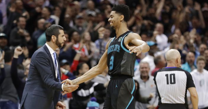 Charlotte Hornets' Jeremy Lamb (3) is congratulated by coach James Borrego after his go-ahead basket against the Toronto Raptors during the second half of an NBA basketball game in Charlotte, N.C., Friday, April 5, 2019. (AP Photo/Chuck Burton)