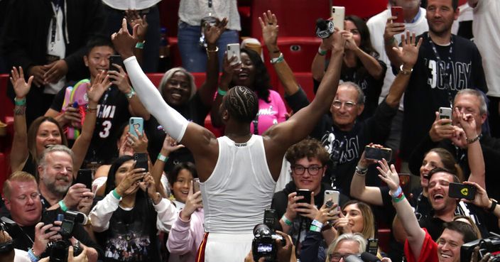 Miami Heat guard Dwyane Wade waves to the crowd after playing his final home game, against the Philadelphia 76ers, Tuesday, April 9, 2019, in Miami. Wade is retiring. (AP Photo/Lynne Sladky)