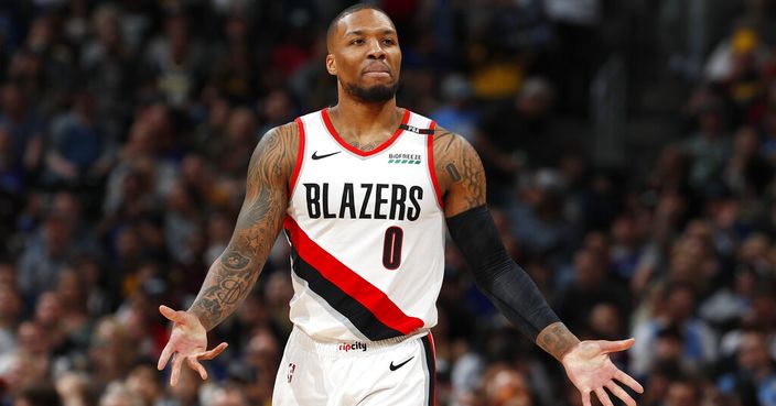 Portland Trail Blazers guard Damian Lillard reacts after being called for a foul against the Denver Nuggets during the second half of an NBA basketball game Friday, April 5, 2019, in Denver. The Nuggets won 119-110. (AP Photo/David Zalubowski)