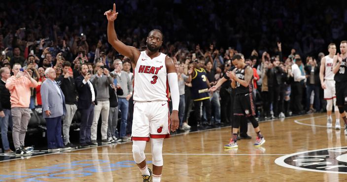 Miami Heat guard Dwyane Wade (3) acknowledges the crowd's cheers after playing in the final NBA basketball game of his career, against the Brooklyn Nets on Wednesday, April 10, 2019, in New York. (AP Photo/Kathy Willens)