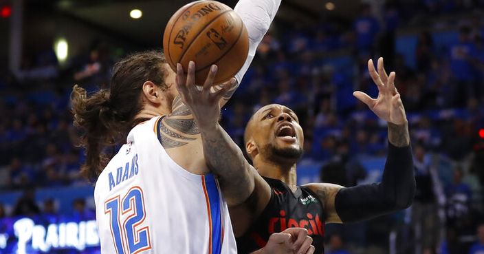 Portland Trail Blazers guard Damian Lillard (0) goes to the basket as Oklahoma City Thunder center Steven Adams (12) defends in the second half of Game 4 of an NBA basketball first-round playoff series Sunday, April 21, 2019, in Oklahoma City. Portland won 111-98. (AP Photo/Alonzo Adams)