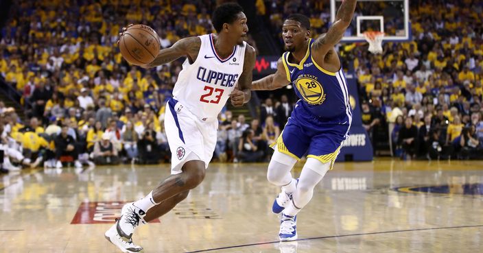 OAKLAND, CALIFORNIA - APRIL 24:  Lou Williams #23 of the LA Clippers drives on Alfonzo McKinnie #28 of the Golden State Warriors during Game Five of the first round of the 2019 NBA Western Conference Playoffs at ORACLE Arena on April 24, 2019 in Oakland, California. NOTE TO USER: User expressly acknowledges and agrees that, by downloading and or using this photograph, User is consenting to the terms and conditions of the Getty Images License Agreement. (Photo by Ezra Shaw/Getty Images)