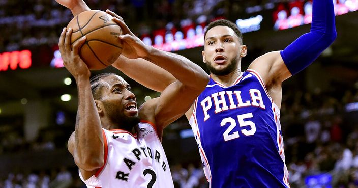 Toronto Raptors forward Kawhi Leonard (2) looks for the shot as Philadelphia 76ers guard Ben Simmons (25) defends during the second half of Game 1 of a second-round NBA basketball playoff series, in Toronto, Saturday, April 27, 2019. (Frank Gunn/The Canadian Press via AP)