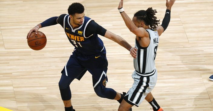 Denver Nuggets guard Jamal Murray, left, looks to move the ball as San Antonio Spurs guard Patty Mills defends in the second half of Game 7 of an NBA basketball first-round playoff series, Saturday, April 27, 2019, in Denver. The Nuggets won 90-86 to advance to the second round against Portland. (AP Photo/David Zalubowski)