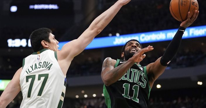 Boston Celtics' Kyrie Irving shoots past Milwaukee Bucks' Ersan Ilyasova during the second half of Game 1 of a second round NBA basketball playoff series Sunday, April 28, 2019, in Milwaukee. The Celtics won 112-90 to take a 1-0 lead in the series. (AP Photo/Morry Gash)
