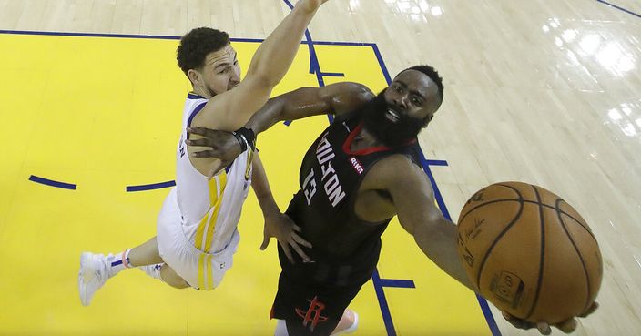 Houston Rockets guard James Harden, right, shoots against Golden State Warriors guard Klay Thompson during the second half of Game 1 of a second-round NBA basketball playoff series in Oakland, Calif., Sunday, April 28, 2019. (AP Photo/Jeff Chiu, Pool)