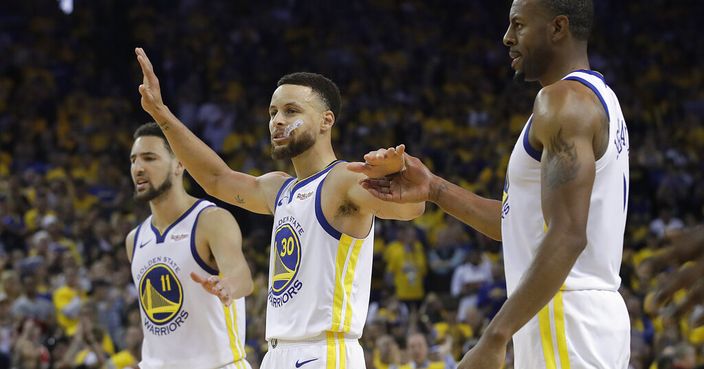 Golden State Warriors' Klay Thompson, from left, celebrates with Stephen Curry and Andre Iguodala during the second half of Game 1 of a second-round NBA basketball playoff series against the Houston Rockets in Oakland, Calif., Sunday, April 28, 2019. (AP Photo/Jeff Chiu)