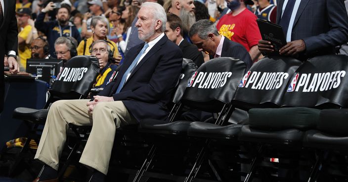 San Antonio Spurs head coach Gregg Popovich sits on the bench before facing the Denver Nuggets in Game 7 of an NBA basketball first-round playoff series Saturday, April 27, 2019, in Denver. (AP Photo/David Zalubowski)