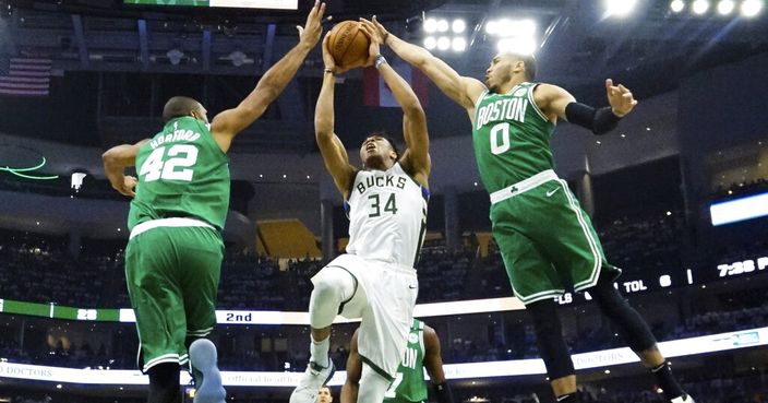 Milwaukee Bucks' Giannis Antetokounmpo shoots between Boston Celtics' Al Horford (42) and Jayson Tatum during the first half of Game 2 of a second round NBA basketball playoff series Tuesday, April 30, 2019, in Milwaukee. (AP Photo/Morry Gash)