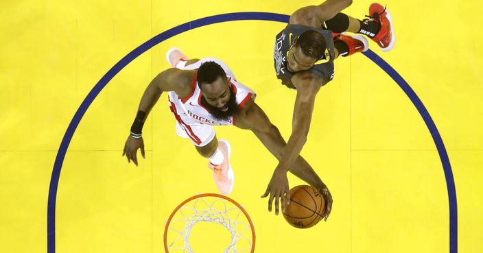 Houston Rockets' James Harden, left, goes up for a shot as Golden State Warriors' Kevin Durant defends during the first half of Game 2 of a second-round NBA basketball playoff series in Oakland, Calif., Tuesday, April 30, 2019. (AP Photo/Jeff Chiu)
