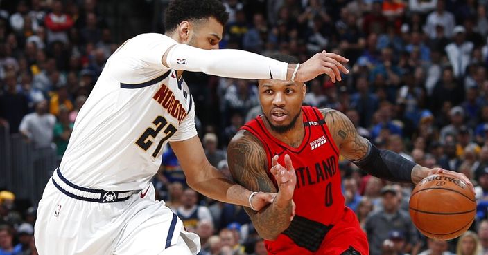 Portland Trail Blazers guard Damian Lillard, right, drives as Denver Nuggets guard Jamal Murray defends during the second half of Game 2 of an NBA basketball second-round playoff series Wednesday, May 1, 2019, in Denver. Portland won 97-90. (AP Photo/David Zalubowski)