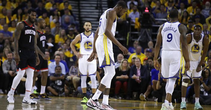 Golden State Warriors' Kevin Durant, center, limps off the court during the second half of Game 5 of the team's second-round NBA basketball playoff series against the Houston Rockets on Wednesday, May 8, 2019, in Oakland, Calif. (AP Photo/Ben Margot)