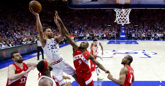 Philadelphia 76ers' Ben Simmons (25) goes up for a shot against Toronto Raptors' Serge Ibaka (9) as Kawhi Leonard (2) and Marc Gasol (33) defend during the second half of Game 6 of a second-round NBA basketball playoff series Thursday, May 9, 2019, in Philadelphia. (AP Photo/Chris Szagola)