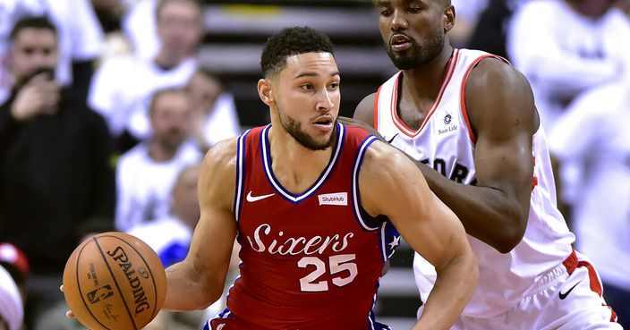 Toronto Raptors center Serge Ibaka (9) charges Philadelphia 76ers guard Ben Simmons (25) during the second half of an NBA Eastern Conference semifinal basketball game in Toronto on Sunday, May 12, 2019. (Frank Gunn/The Canadian Press via AP)
