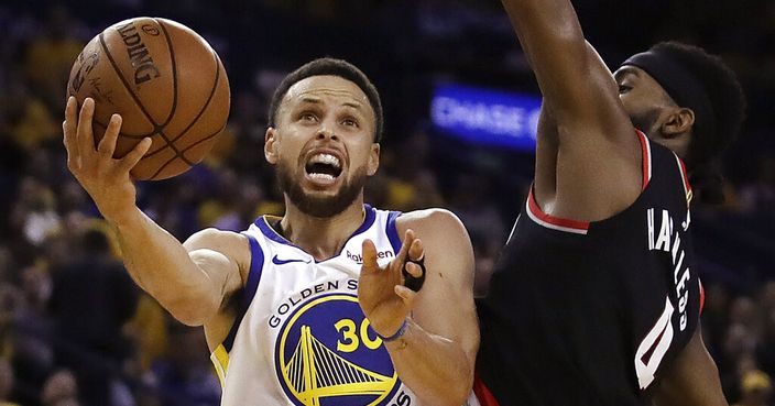 Golden State Warriors' Stephen Curry, left, lays up a shot past Portland Trail Blazers' Maurice Harkless during the first half of Game 1 of the NBA basketball playoffs Western Conference finals Tuesday, May 14, 2019, in Oakland, Calif. (AP Photo/Ben Margot)