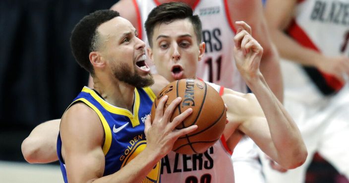 Golden State Warriors guard Stephen Curry, left, drives to the basket against Portland Trail Blazers forward Zach Collins (33) during the second half of Game 3 of the NBA basketball playoffs Western Conference finals Saturday, May 18, 2019, in Portland, Ore. The Warriors won 110-99. (AP Photo/Ted S. Warren)