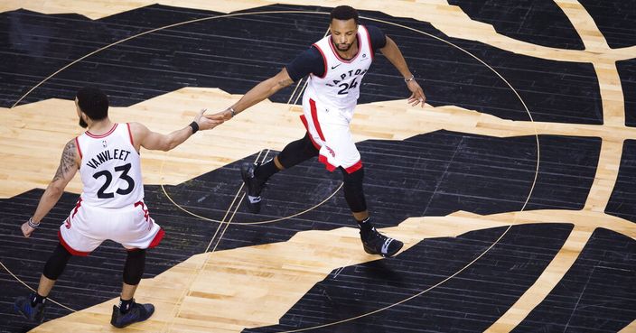 Toronto Raptors forward Norman Powell (24) celebrates his basket with Fred VanVleet (23) during the second half of Game 4 of the team's NBA basketball playoffs Eastern Conference finals against the Milwaukee Buck, Tuesday, May 21, 2019, in Toronto. (Nathan Denette/The Canadian Press via AP)