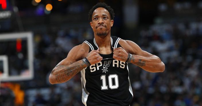 San Antonio Spurs guard DeMar DeRozan rips his jersey as he heads to the bench after drawing his second personal foul against the Denver Nuggets early in the first half of Game 2 of an NBA basketball playoff series Tuesday, April 16, 2019, in Denver. (AP Photo/David Zalubowski)