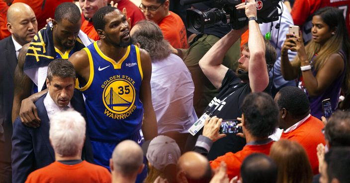 Golden State Warriors forward Kevin Durant glances up at the stands as he walks off the court after sustaining an injury during first half basketball action in Game 5 of the NBA Finals in Toronto, Monday, June 10, 2019. (Chris Young/The Canadian Press via AP)