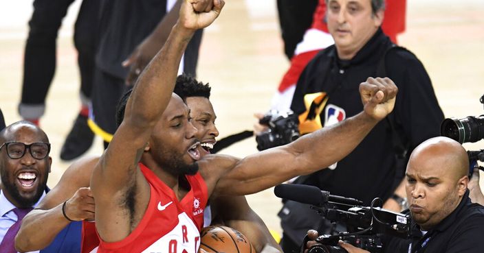 Toronto Raptors forward Kawhi Leonard (2) and guard Kyle Lowry, back, celebrate after the Raptors defeated the Golden State Warriors 114-110 in Game 6 of basketball’s NBA Finals, Thursday, June 13, 2019, in Oakland, Calif. (Frank Gunn/The Canadian Press via AP)
