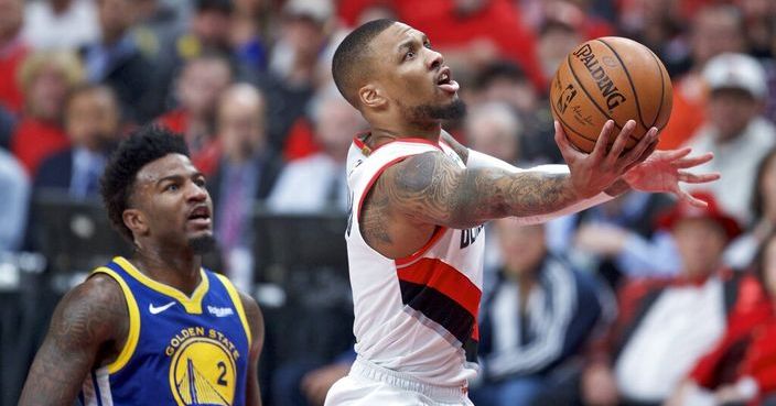 Portland Trail Blazers guard Damian Lillard, right, shoots near Golden State Warriors forward Jordan Bell during the first half of Game 4 of the NBA basketball playoffs Western Conference finals Monday, May 20, 2019, in Portland, Ore. (AP Photo/Craig Mitchelldyer)