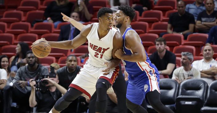 Miami Heat center Hassan Whiteside (21) drives against Philadelphia 76ers center Jahlil Okafor during the first half of an NBA preseason basketball game, Friday, Oct. 21, 2016, in Miami. (AP Photo/Alan Diaz)