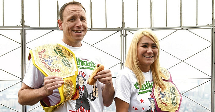 Eleven-time and defending men’s champion Joey Chestnut, left, and defending women’s champion Miki Sudo pose together during Nathan's Famous international Fourth of July hot dog eating contest weigh-in at the Empire State Building on Wednesday, July 3, 2019, in New York. (Photo by Evan Agostini/Invision