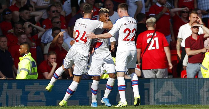 Crystal Palace's Patrick van Aanholt, center, celebrates with teammates after scoring his side's second goal during the English Premier League soccer match between Manchester United and Crystal Palace at Old Trafford in Manchester, England Saturday, Aug, 24, 2019. (AP Photo/Alastair Grant)