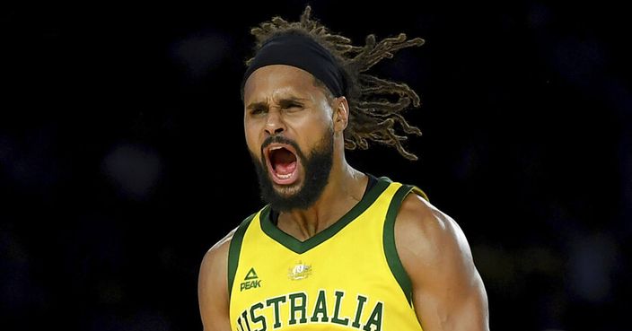 Australia's Patty Mills celebrates after shooting a 3-pointer during their exhibition basketball game against the U.S in Melbourne, Saturday, Aug. 24, 2019. (AP Photo/Andy Brownbill)
