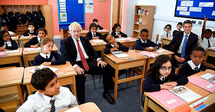 Britain's Prime Minister Boris Johnson, center left, visits Pimlico Primary school in London, Tuesday July 10, 2018, to meet staff and students. (Toby Melville/Pool via AP)
