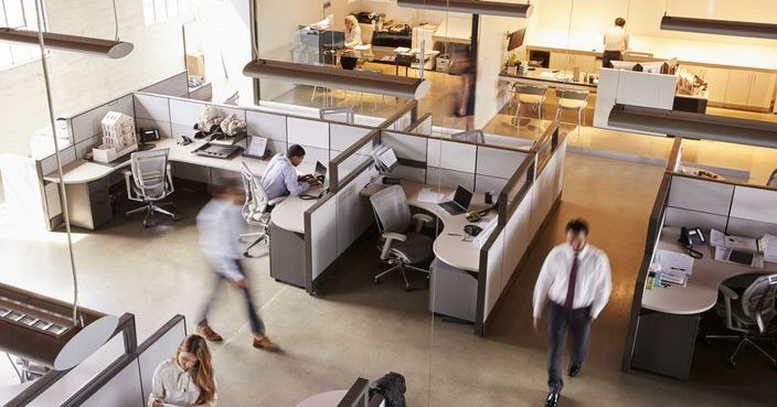 Elevated view of staff working in a busy open plan office