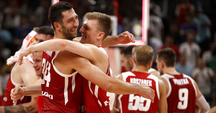 Adam Hrycaniuk, left, and Karol Gruszecki of Poland celebrate after their overtime win against China in their group phase basketball game in the FIBA Basketball World Cup at the Cadillac Arena in Beijing, Monday, Sept. 2, 2019. (AP Photo/Mark Schiefelbein)