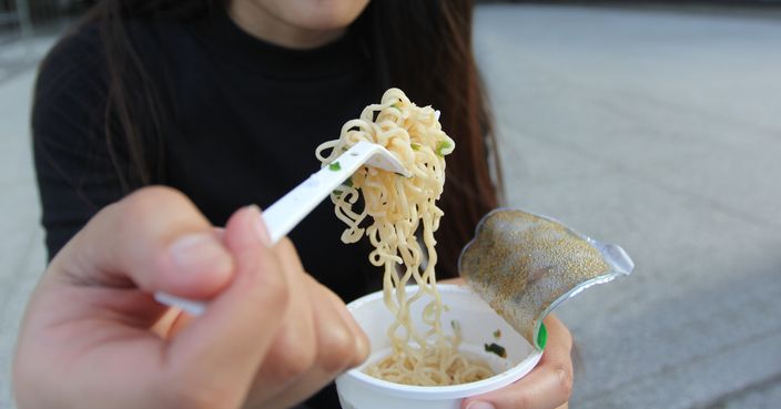 Young woman hand holding plastic fork of instant noodles, Sodium diet high risk kidney failure, Healthy Eating