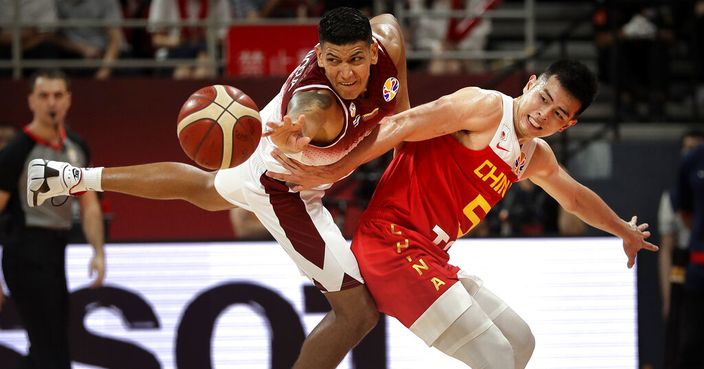 Jhornan Zamora of Venezuela and Fang Shuo of China battle for a loose bal during their group phase game in the FIBA Basketball World Cup at the Cadillac Arena in Beijing, Wednesday, Sept. 4, 2019. (AP Photo/Mark Schiefelbein)