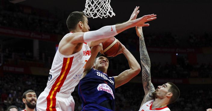Bogdan Bogdanovic of Serbia is blocked by Victor Claver, left, and Juancho Hernangomez, right, of Spain as he attempt to shoot during their Group J second phase match for the FIBA Basketball World Cup, at the Wuhan Sports Center in Wuhan in central China's Hubei province, Sunday, Sept. 8, 2019. (AP Photo/Andy Wong)