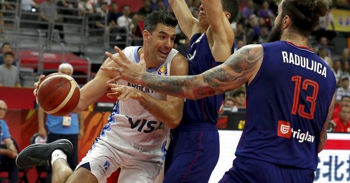Argentina's Luis Scola tries to get past Serbian defenders during a quarterfinal match for the FIBA Basketball World Cup in Dongguan in southern China's Guangdong province on Tuesday, Sept. 10, 2019. Argentina beats Serbia 97-87. (AP Photo/Ng Han Guan)