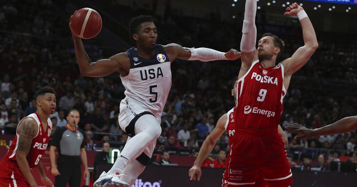 United States' Donovan Mitchell attempts to pass the ball near Poland's Mateusz Ponitka at right during a consolation playoff game for the FIBA Basketball World Cup at the Cadillac Arena in Beijing on Saturday, Sept. 14, 2019. U.S. defeated Poland 87-74 (AP Photo/Ng Han Guan)