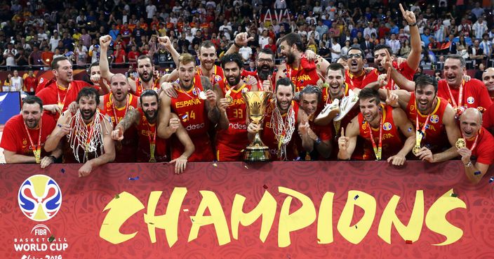 Members of Spain's team celebrate with the Naismith Trophy after they beat Argentina in their first-place match in the FIBA Basketball World Cup at the Cadillac Arena in Beijing, Sunday, Sept. 15, 2019. (AP Photo/Mark Schiefelbein)