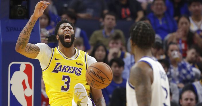 Los Angeles Lakers forward Anthony Davis (3) yells after dunking against the Golden State Warriors during the first half of a preseason NBA basketball game in San Francisco, Saturday, Oct. 5, 2019. (AP Photo/Jeff Chiu)