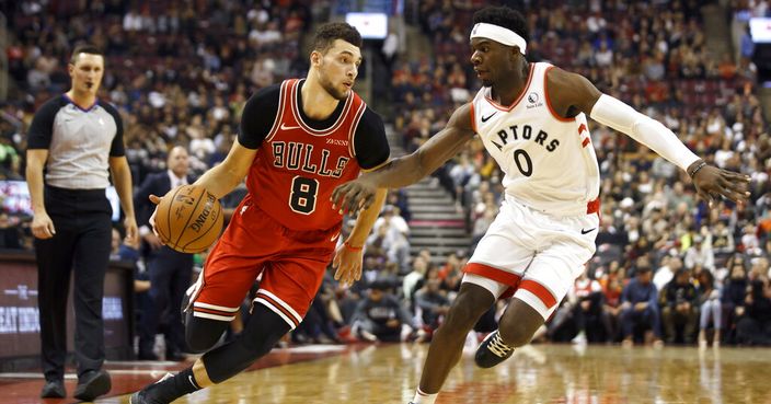 Chicago Bulls guard Zach LaVine (8) drives against Toronto Raptors guard Terence Davis (0) during the first half of their NBA basketball game in Toronto, Sunday, Oct. 13, 2019. (Cole Burston/The Canadian Press via AP)