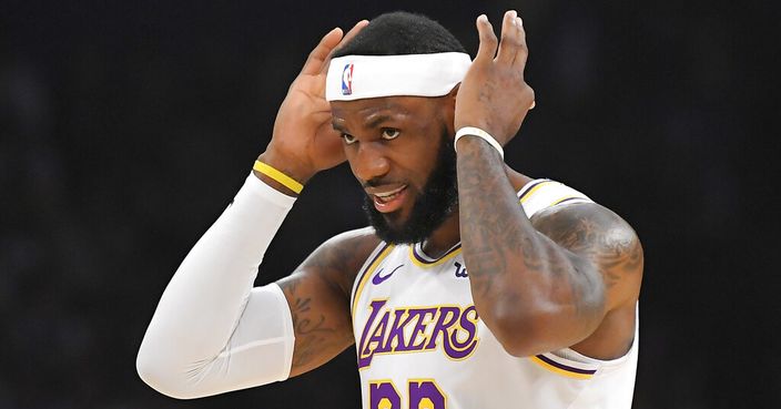 Los Angeles Lakers forward LeBron James adjusts his headband during the first half of the team's preseason NBA basketball game against the Golden State Warriors on Wednesday, Oct. 16, 2019, in Los Angeles. (AP Photo/Mark J. Terrill)