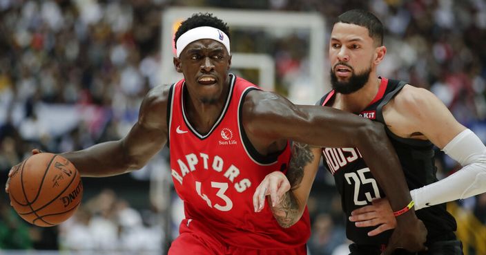 Toronto Raptors' Pascal Siakam, left, is pressured by Houston Rockets' Austin Rivers during the first half of an NBA preseason basketball game Thursday, Oct. 10, 2019, in Saitama, near Tokyo. (AP Photo/Jae C. Hong)