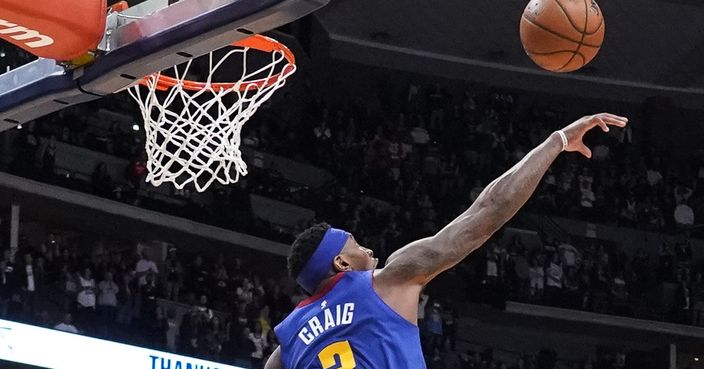 Denver Nuggets forward Torrey Craig (3) blocks a shot by Phoenix Suns' Devin Booker at the end of overtime in an NBA basketball game Friday, Oct. 25, 2019, in Denver. Denver won 108-107. (AP Photo/Jack Dempsey)