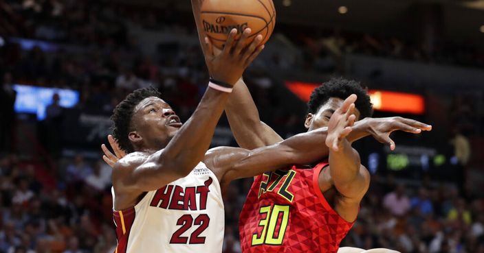 Miami Heat forward Jimmy Butler (22) goes to the basket as Atlanta Hawks center Damian Jones (30) defends during the second half of an NBA basketball game Tuesday, Oct. 29, 2019, in Miami. Miami won 112-97. (AP Photo/Lynne Sladky)