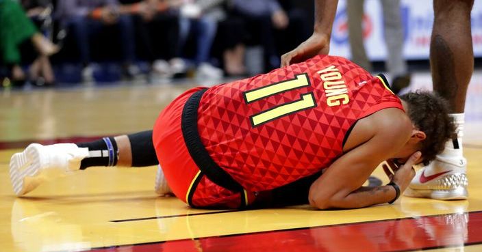 Atlanta Hawks guard Trae Young (11) lies on the court after an injury during the first half of the team's NBA basketball game against the Miami Heat, Tuesday, Oct. 29, 2019, in Miami. (AP Photo/Lynne Sladky)