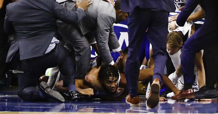 Minnesota Timberwolves' Karl-Anthony Towns lies on the court after an altercation with Philadelphia 76ers' Joel Embiid during the second half of an NBA basketball game Wednesday, Oct. 30, 2019, in Philadelphia. Both players were ejected. The 76ers won 117-95. (AP Photo/Matt Rourke)