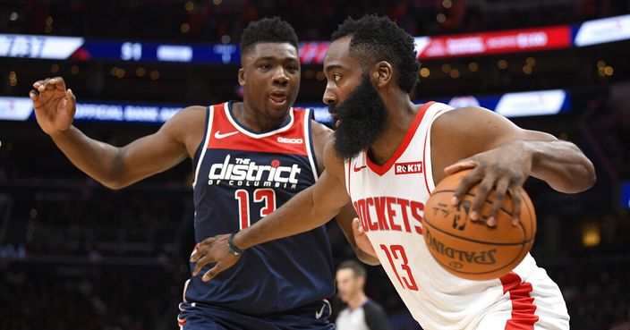 Houston Rockets guard James Harden, front, dribbles the ball as Washington Wizards center Thomas Bryant, back, defends during the first half of an NBA basketball game Wednesday, Oct. 30, 2019, in Washington. (AP Photo/Nick Wass)